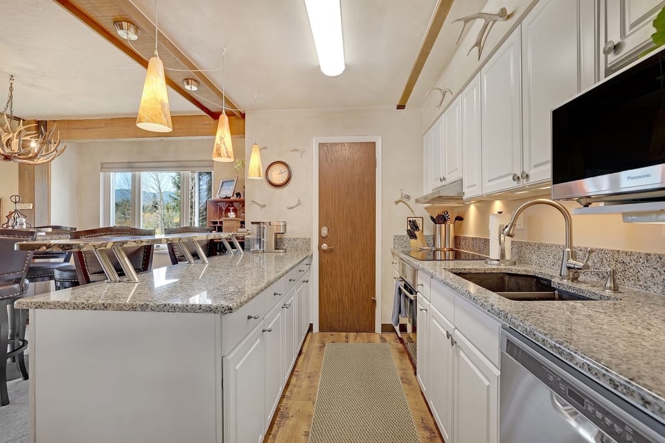Fully stocked modern kitchen with all essential cookware, utensils, and appliances.