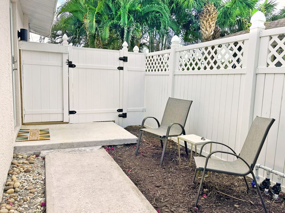 Secluded side patio with comfortable seating and private hot tub.
