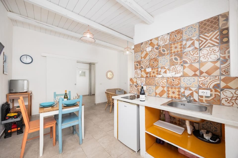 Annex: open-plan living room with seating, dining area, kitchenette, A/C, WiFi internet, and satellite TV