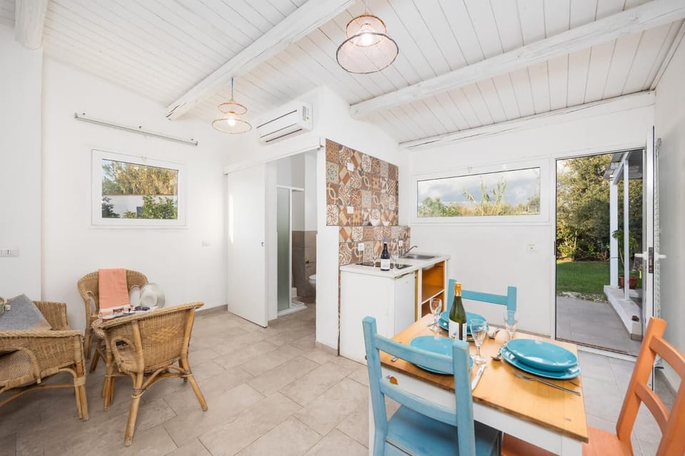 Annex: open-plan living room with seating, dining area, kitchenette, A/C, WiFi internet, and satellite TV