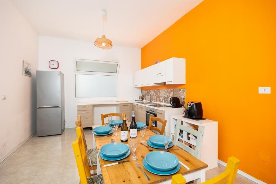 Open-plan living room with sofa, dining area, kitchen, WiFi internet, and satellite TV