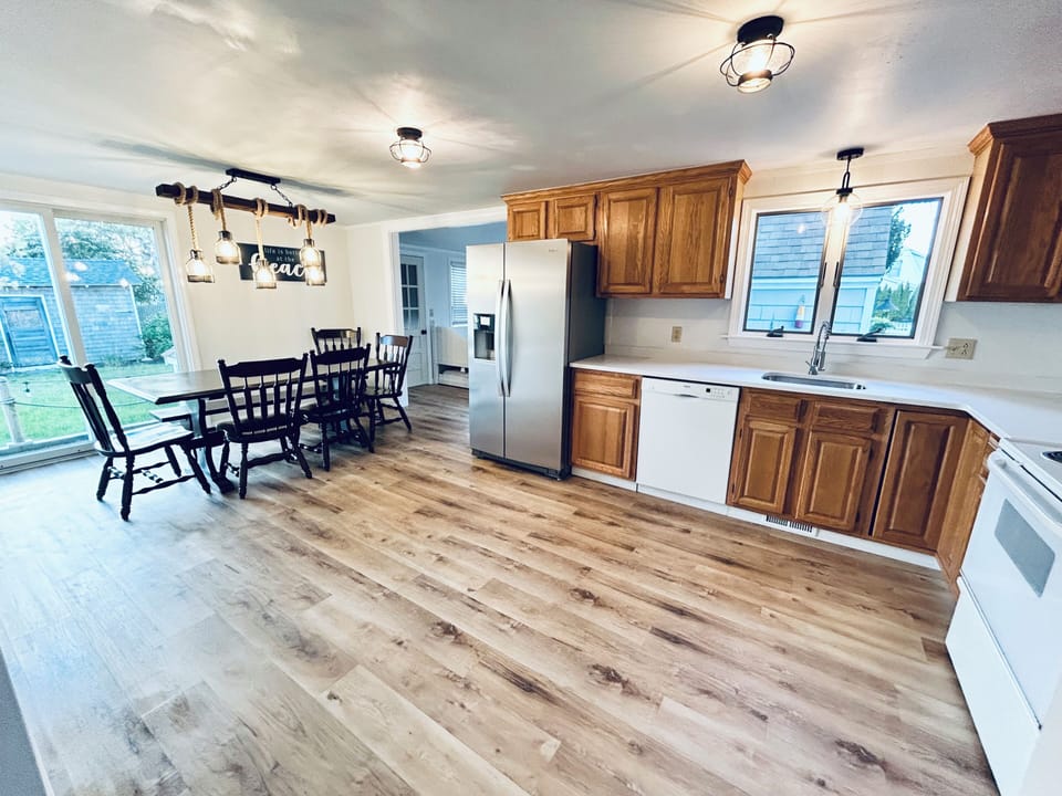 Kitchen and dining area. Sliders to back patio dining and gas grill. 