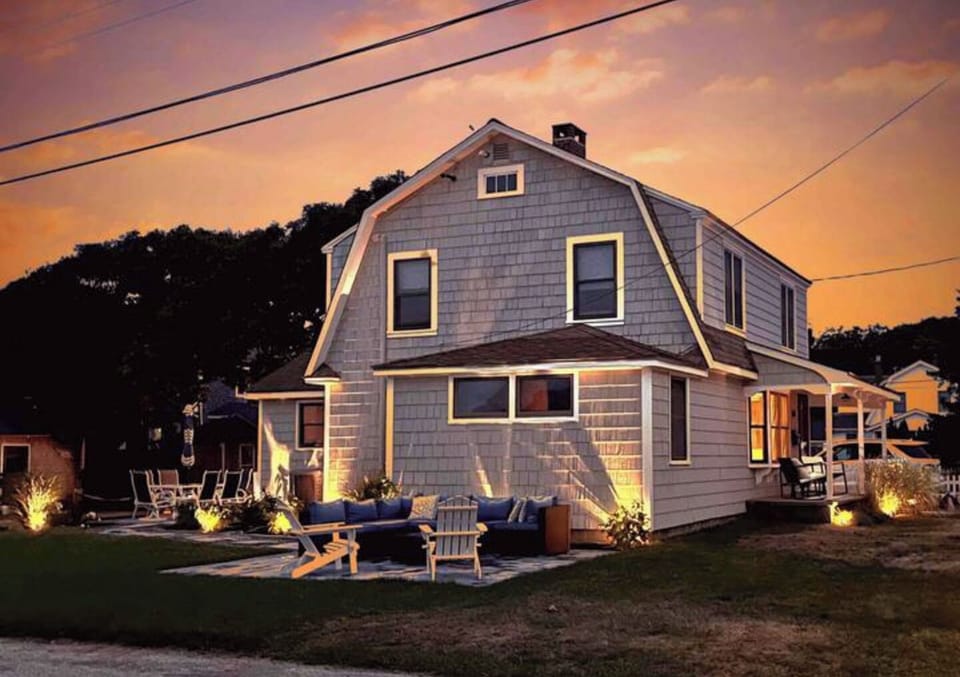 Side view with night-time landscape lights for easy outdoor entertaining.