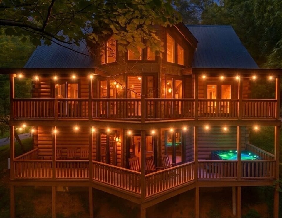 Warmly lit mountain cabin with wraparound decks and private hot tub