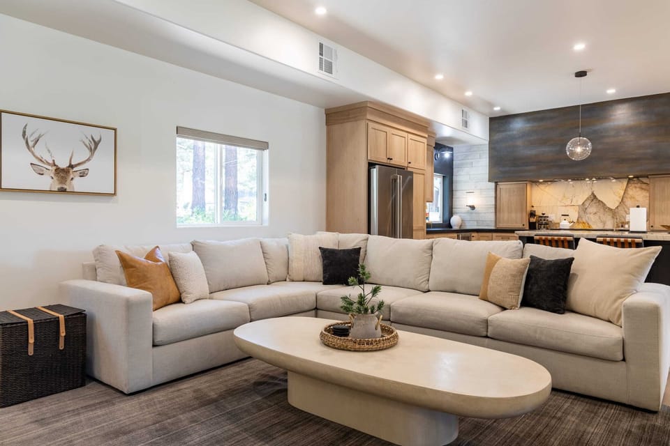 Open concept living area with gas fireplace, smart TV, and chef's kitchen