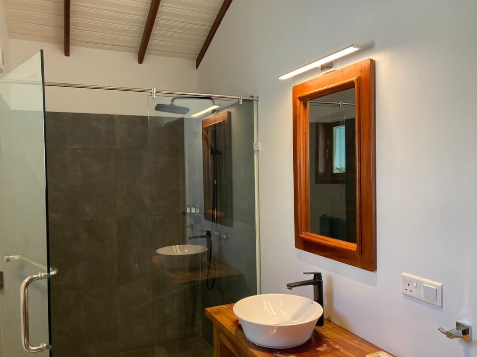 Deluxe Bungalow, Pool View | Bathroom | Shower, hair dryer (on request), towels, soap