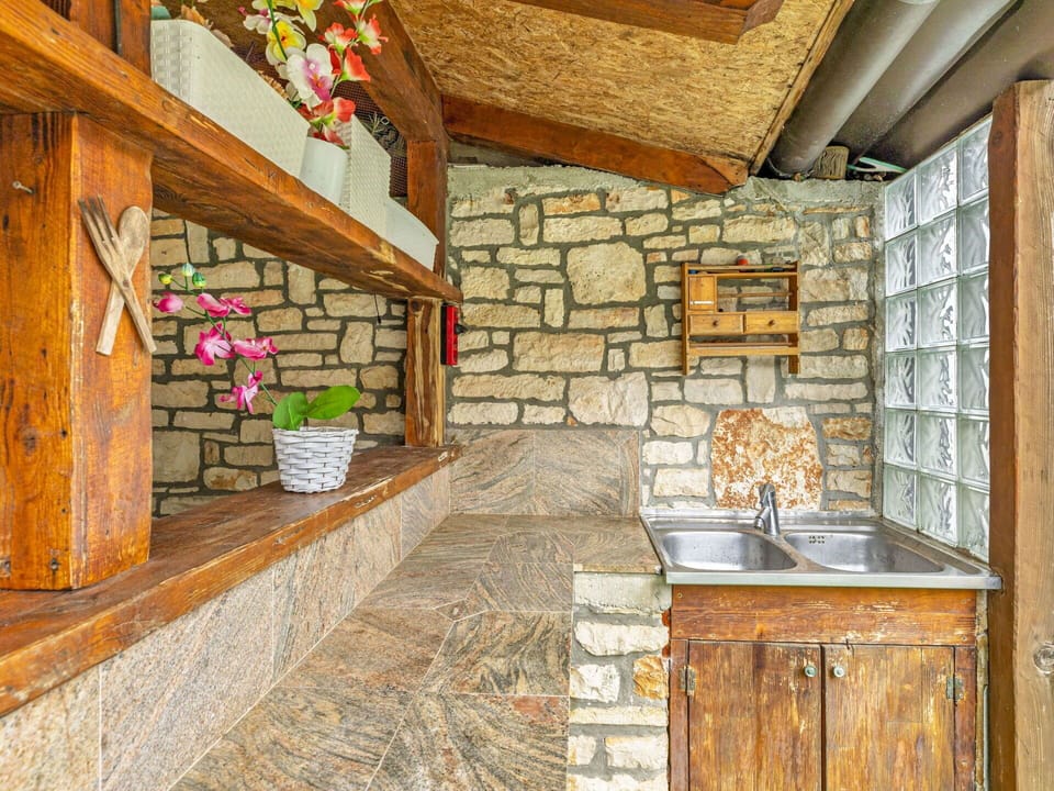 Building, Cabinetry, Plant, Countertop, Wood, Interior Design, Flooring, Brick, Floor, Houseplant
