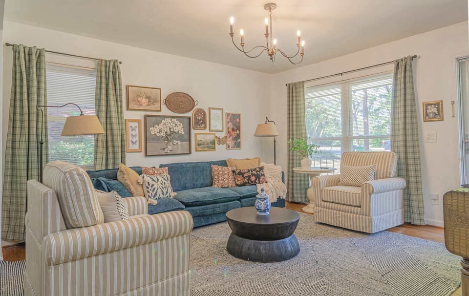 Sun-drenched living room with plenty of seating.

