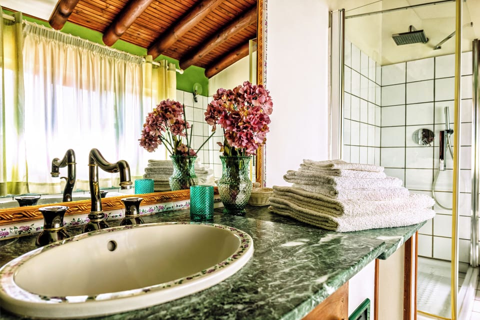 Deluxe Suite, 2 Bedrooms, Ensuite, Sea View | Bathroom | Shower, rainfall showerhead, hair dryer, towels