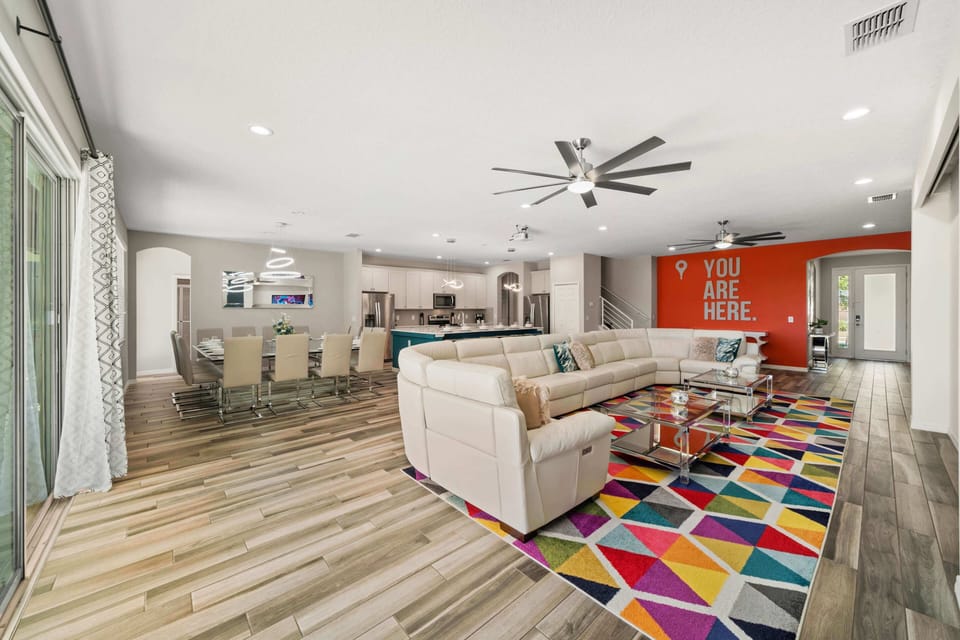 - Colorful living room at Orlando family vacation home  
- Spacious open floor plan with stylish modern design  
- Fun villa rental near Disney with bold unique decor