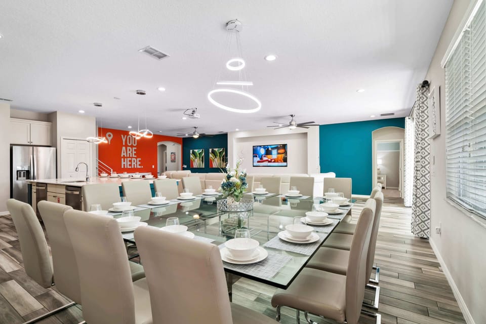 - Luxury dining space with seating for large families  
- Orlando vacation rental perfect for family gatherings  
- Modern open concept dining area with bright accents