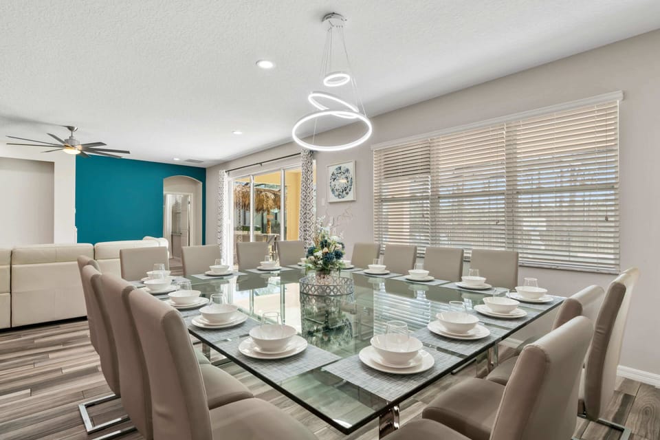 - Huge dining table with seating for the whole family  
- Orlando vacation rental for reunions and large groups  
- Family villa near Disney with elegant dining space