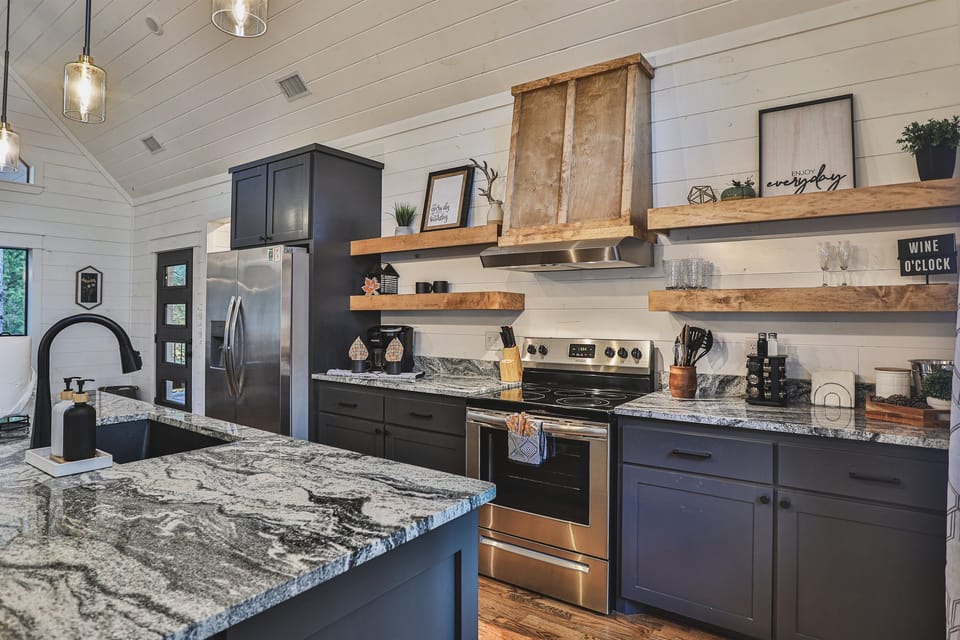 Chef’s Kitchen: Modern open-concept layout with stainless appliances, stone counters, and 1G Fiber WiFi.