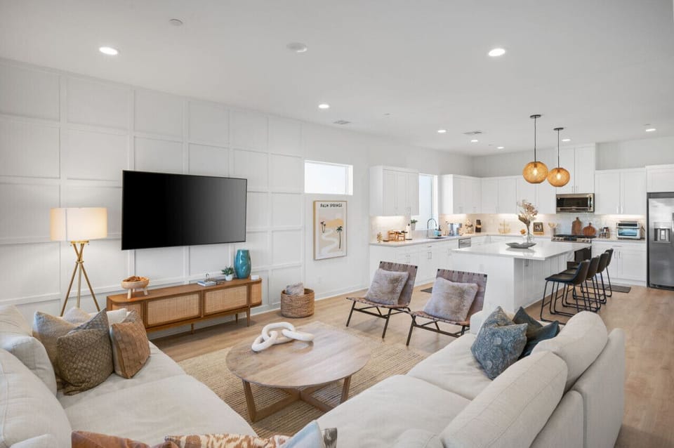 Spacious great room w/ inviting sofas, a statement coffee table & seamless indoor-outdoor flow.