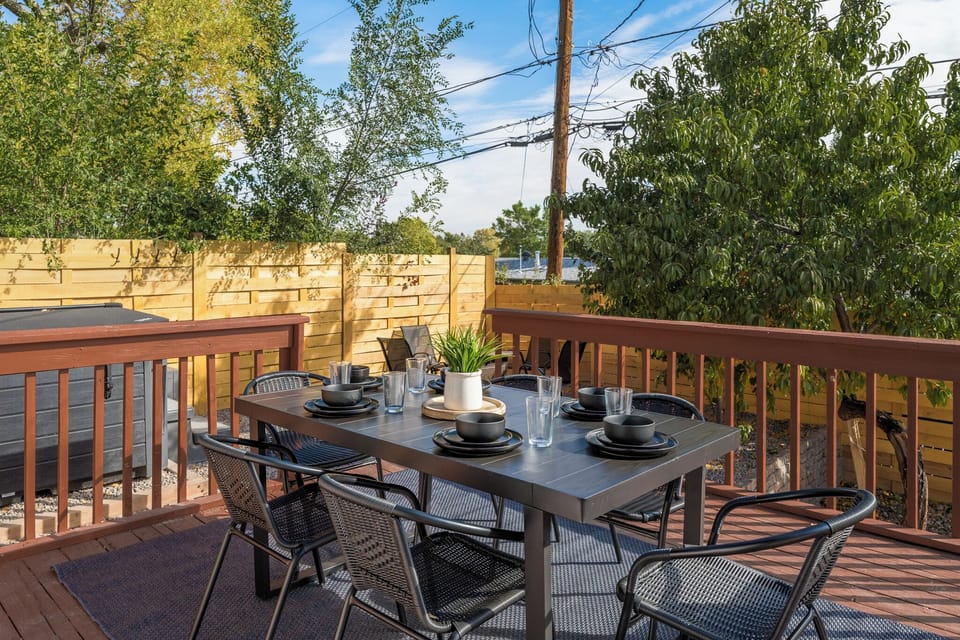 Enjoy the backyard retreat with an outdoor dining set, cozy living space, and firepit for evenings under the stars. Soak in the hot tub or gather with loved ones—this inviting space is perfect for fun, relaxation, and making memories.