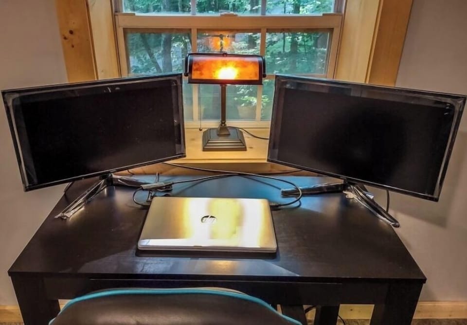 Fully-equipped work station in game room (monitors and printer)