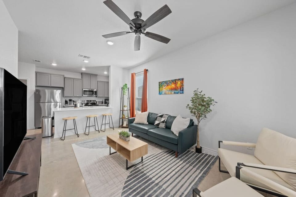 Enjoy a stylish, open-concept layout perfect for relaxing or entertaining—complete with a fully equipped kitchen, cozy seating, and smart TV for your stay.