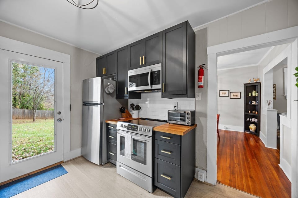 Kitchen offers access to the back fenced yard