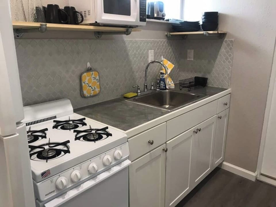 The Kitchen.  It may look small but it can handle all your cooking needs.  Stocked with pots/pans, cooking utensil and place setting for 4. 