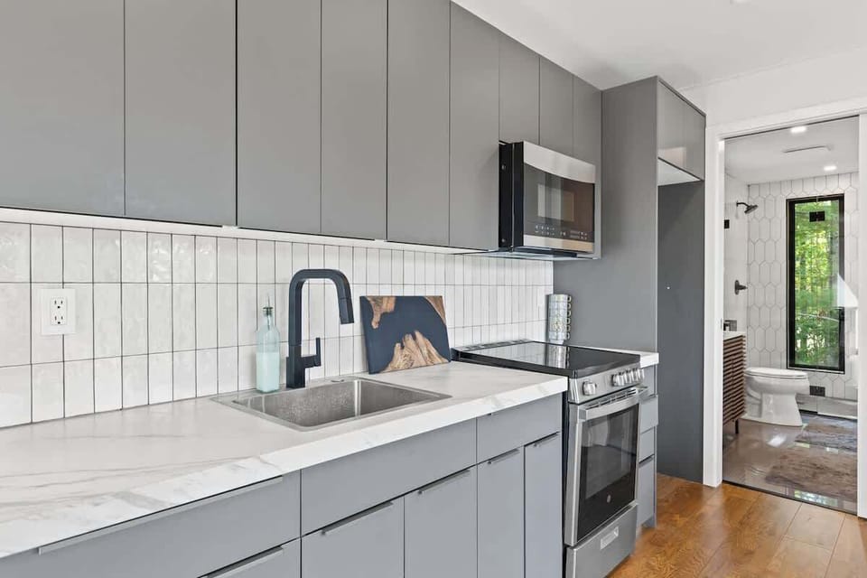 Stylish kitchen with sleek cabinetry, full-size appliances, and open layout.