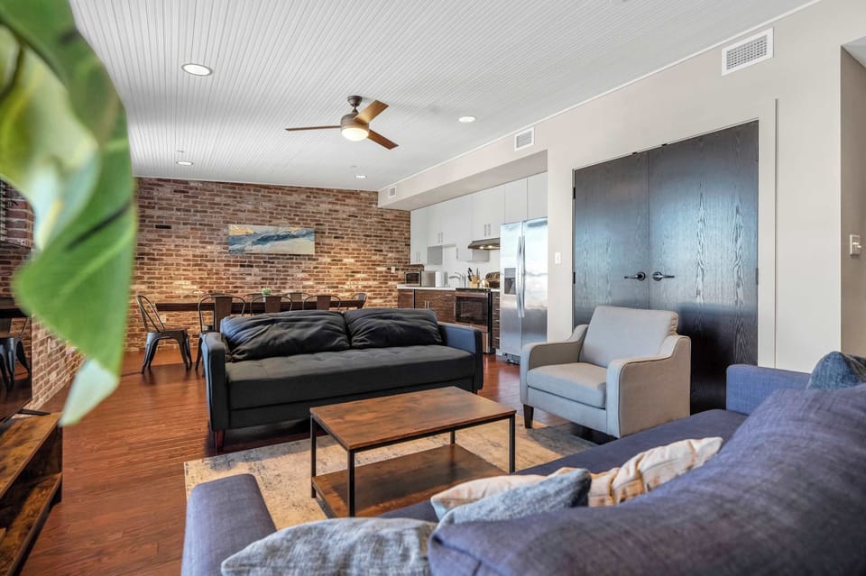 Living Room: Enjoy this comfortable living space with large windows, a flat-screen TV, and plush seating perfect for unwinding after a day of exploring.