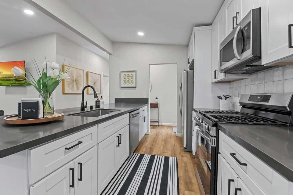 essential appliances such as a stove, oven, refrigerator, and dishwasher, often arranged for easy workflow. Countertops provide ample workspace, while cabinets and drawers offer organized storage for utensils, cookware, and ingredients. 
