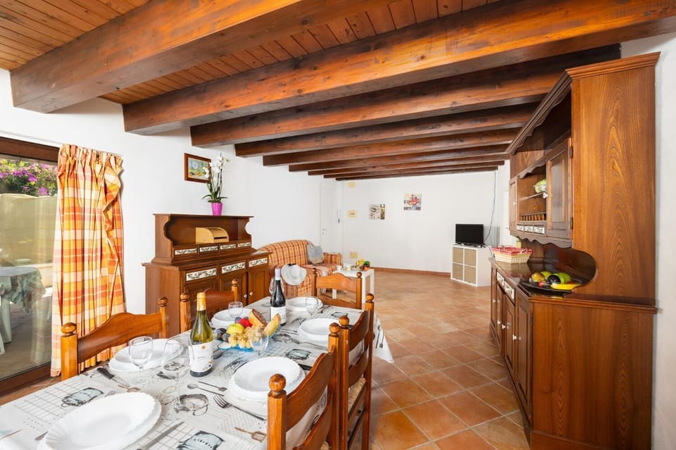 Open-plan living room with sofa, dining area, kitchen, WiFi internet, and satellite TV