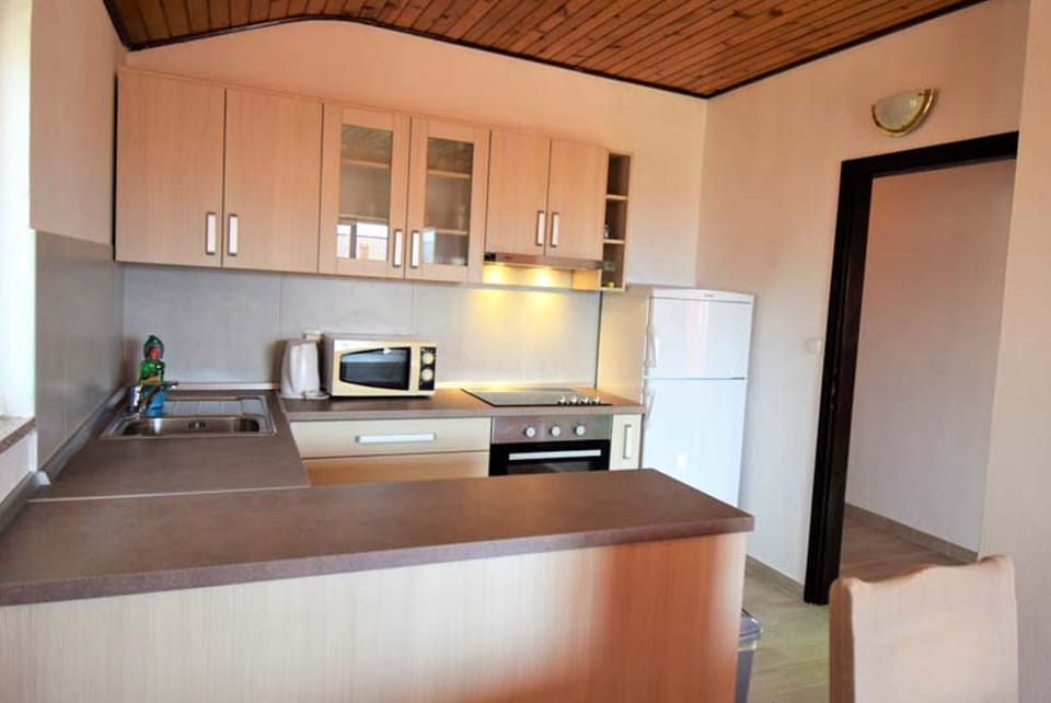 Kitchen with cooking essentials and storage.