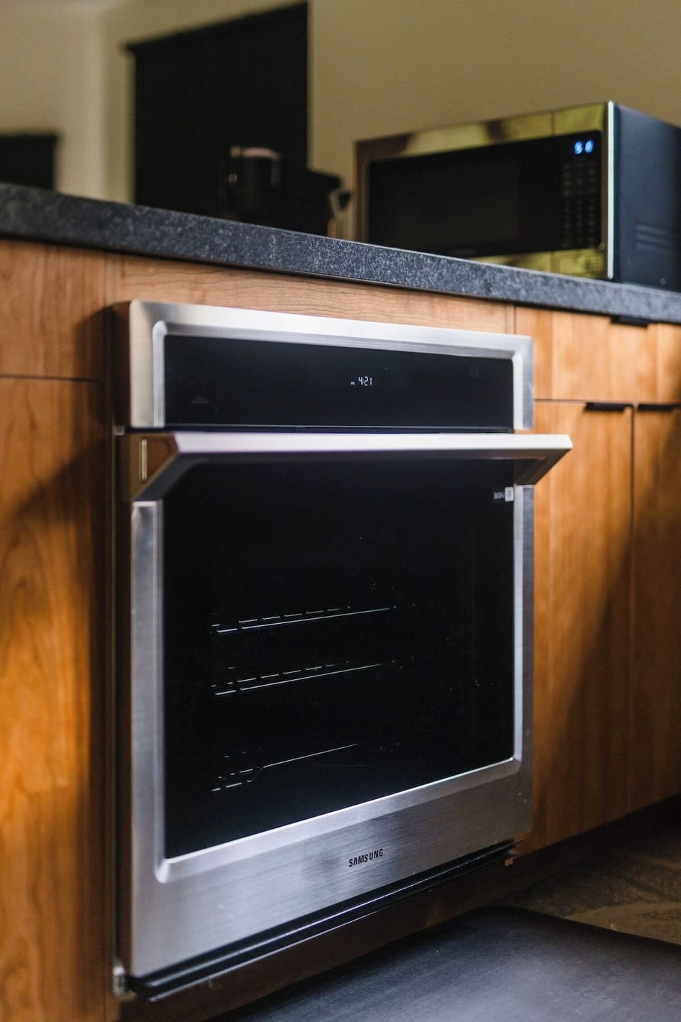 A sleek Samsung oven offers a sophisticated look that complements the kitchen's design. Above the counter, a modern microwave sits conveniently for quick reheating or meal prep.