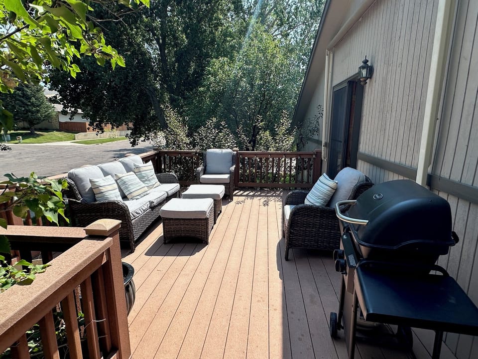 Deck off the dining area with patio furniture (seasonal) and gas grill