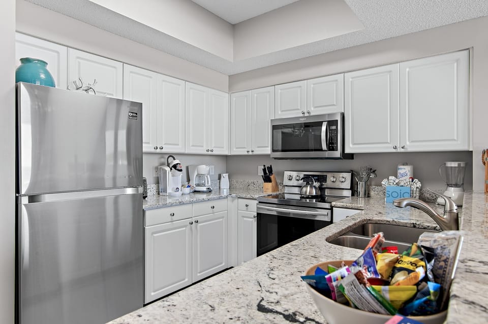 Kitchen has GULF VIEWS, granite countertops, stainless appliances - fully stocked with more than the basics (coffee/tea bar, oils/salt and pepper, Tupperware, plenty of pots/pans/cookware)