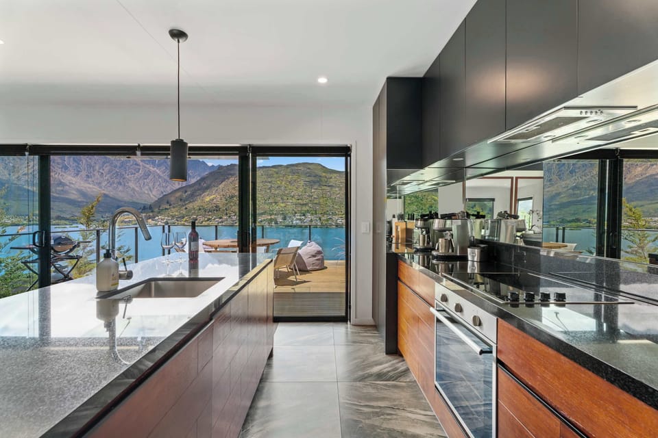 Beautiful, fully equipped kitchen featuring a complete set of modern appliances and a barista-style coffee machine—perfect for enjoying your morning coffee out on the deck while taking in the stunning view.

