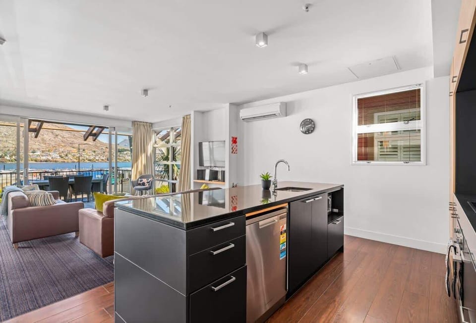 Cook and connect in this open kitchen with breakfast bar seating and lounge flow