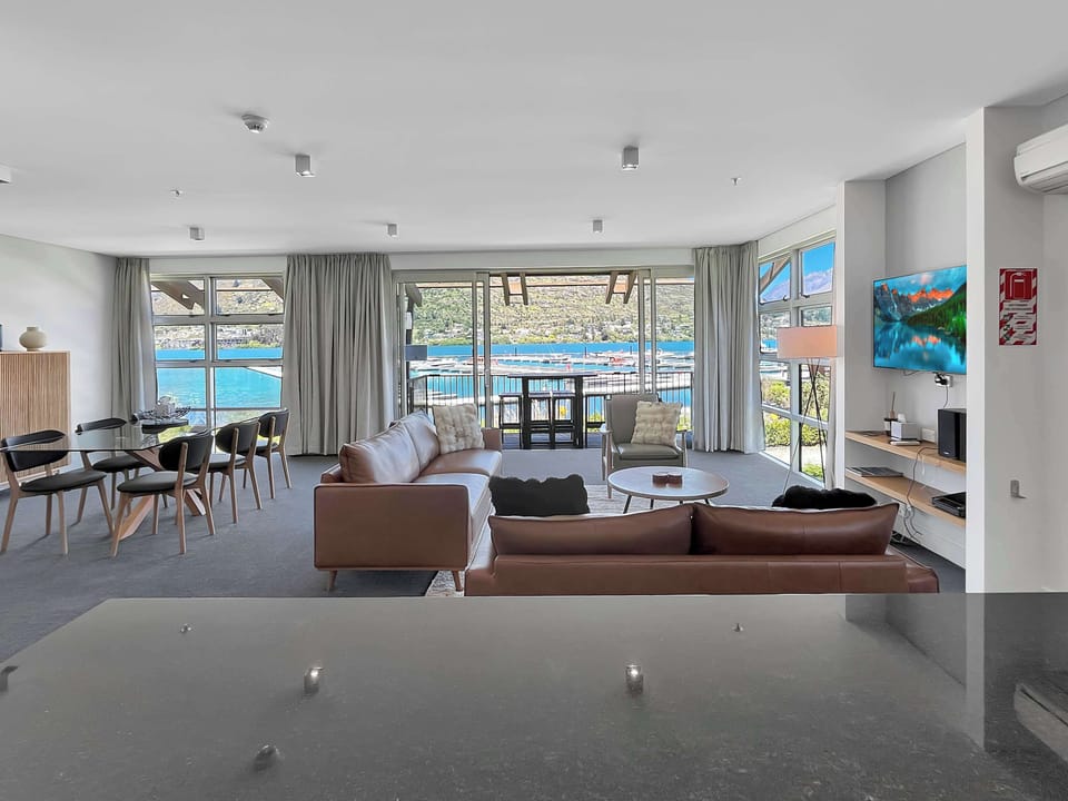 Open-plan living, dining, and kitchen with stunning marina views.
