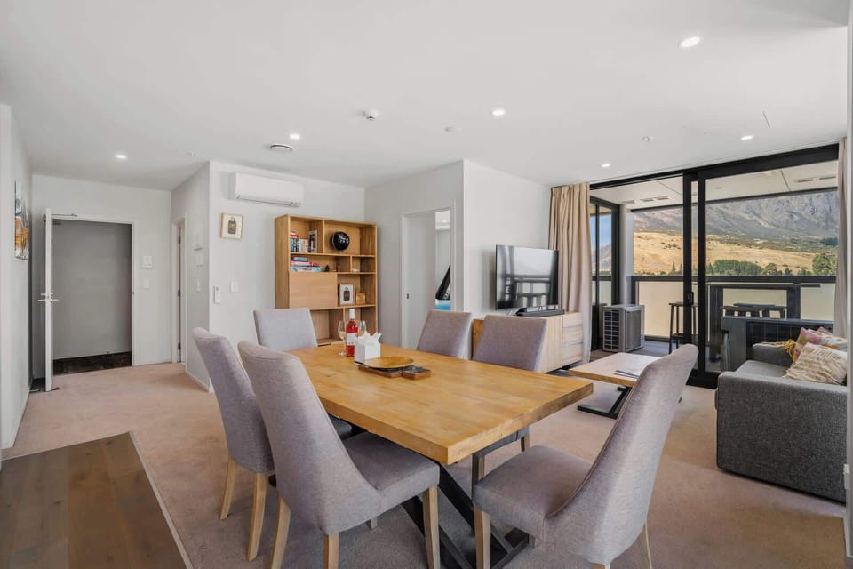 The lovely open plan living, dining and kitchen areas open up to a balcony with spectacular views of the Remarkables Mountains