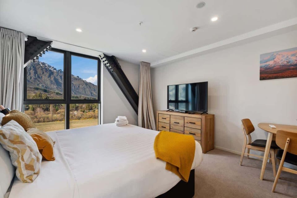 Cozy bedroom setup with stunning alpine outlook