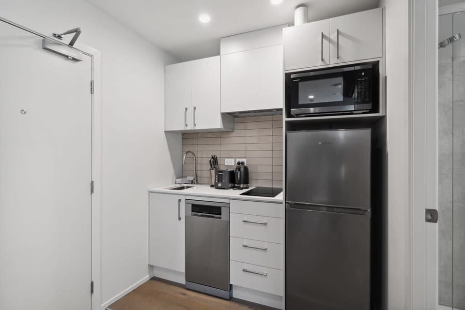 Compact kitchenette with modern appliances and essentials