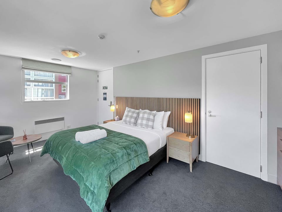 Serene king bedroom with plush bedding and modern design.