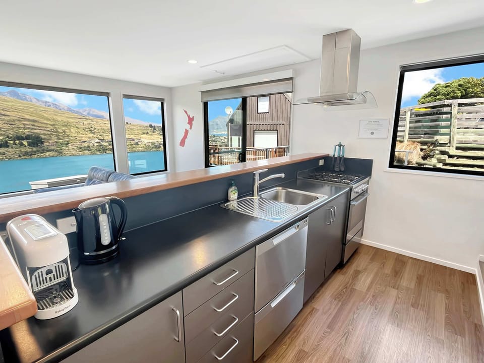 Modern kitchen with gas cooktop and lake outlook