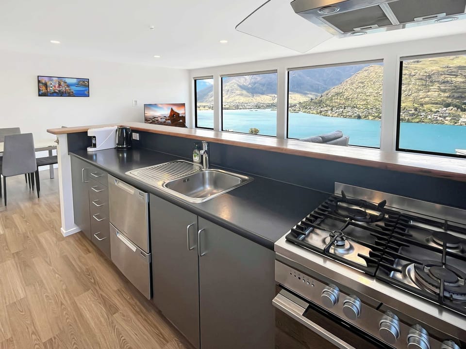Modern kitchen with gas cooktop and lake outlook