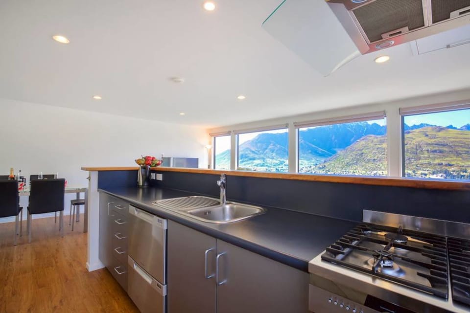 Modern kitchen with stainless steel appliances and mountain vistas