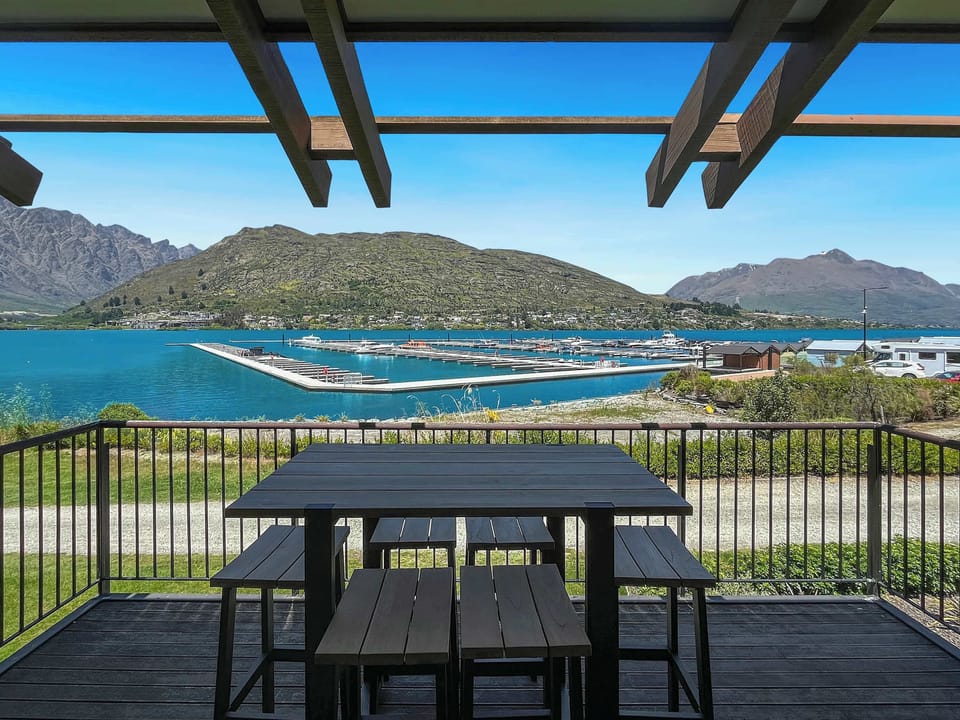 Balcony dining with breathtaking lake and mountain scenery.