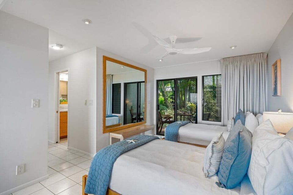 Another angle brightens with mirrors and tile, greenery and light wrapping the room in ease.