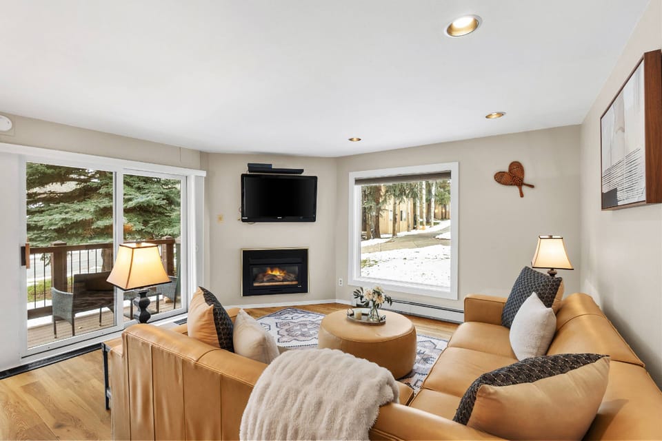 The spacious and comfortable sectional sofa is a perfect spot to unwind and watch your favorite show or sports event by the fire.