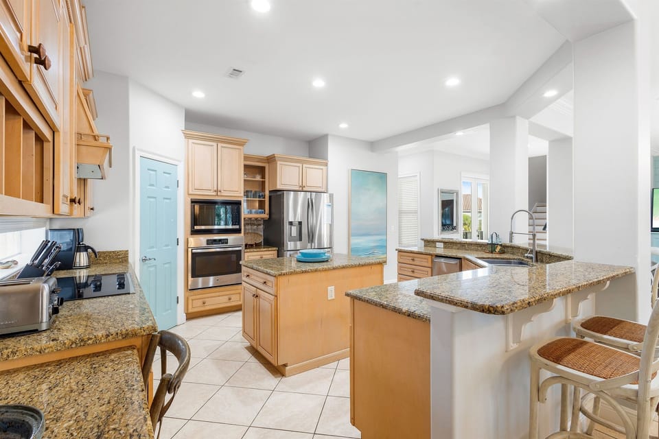 Your spacious gourmet kitchen features granite countertops and stainless appliances, perfect for preparing meals together.