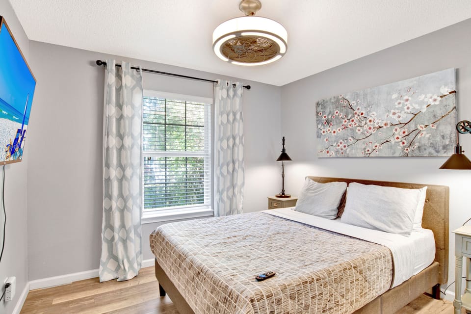 Charming guest bedroom with a comfortable bed and lovely natural light—perfect for a restful night's sleep