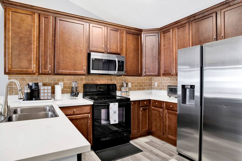 Fully equipped kitchen with a sleek range, microwave, and plenty of counter space to make meal prep a breeze