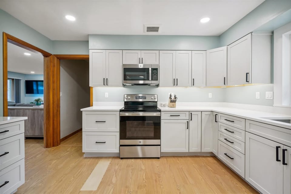 Modern kitchen with sleek cabinetry, stainless steel appliances, and plenty of counter space for preparing meals and snacks during your Seaside stay.