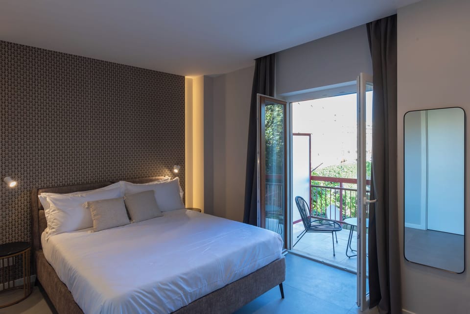 Deluxe Triple Room, Balcony | Free minibar, desk, laptop workspace, soundproofing