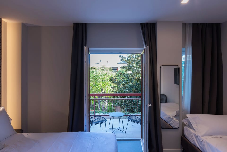 Deluxe Triple Room, Balcony | Free minibar, desk, laptop workspace, soundproofing